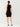 Person wearing a black sleeveless dress on a white background