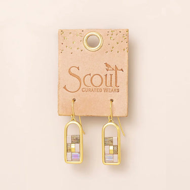 A pair of gold-tone drop earrings with stacked rectangular mosaic inlays, displayed on a tan card labeled 'Scout Curated Wears' against a light beige background.