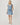 A women wearing a light blue cotton denim dress with an adjustable waistband