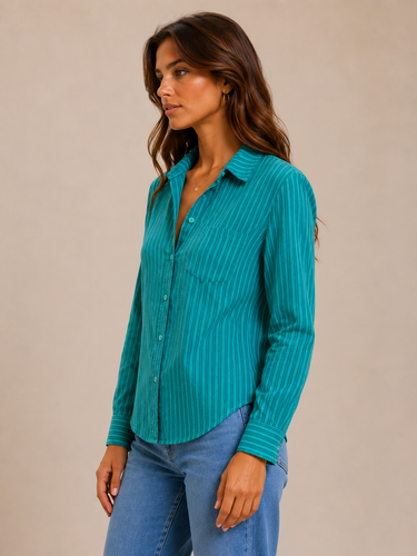 a woman wearing a striped green top and jeans