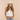 Woman wearing a white tank top and straw hat on a beige background