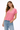 Woman wearing a pink t-shirt and blue jeans on a white background