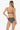Woman wearing a black and white patterned bikini on a white background