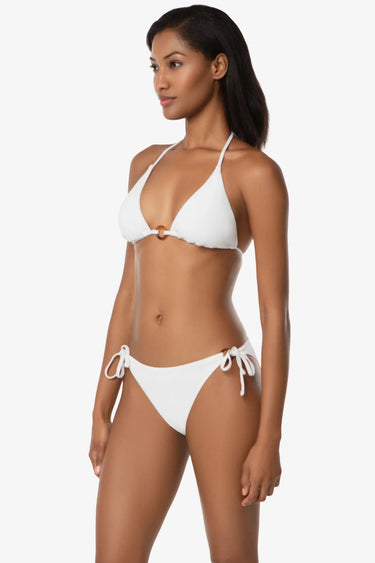 Woman wearing a white bikini on a white background