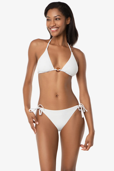 Woman wearing a white bikini against a plain background