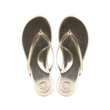 Pair of metallic gold flip-flops on a white background