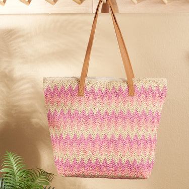 Woven tote bag with pink and green pattern on a beige background