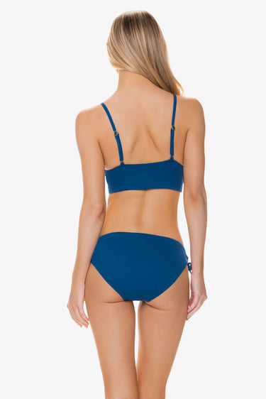 Woman wearing a blue bikini on a white background