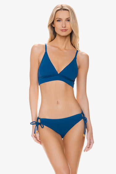Woman wearing a blue bikini set on a white background