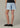 Light blue denim shorts worn by a person on a neutral background