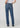 Person wearing blue jeans on a plain background