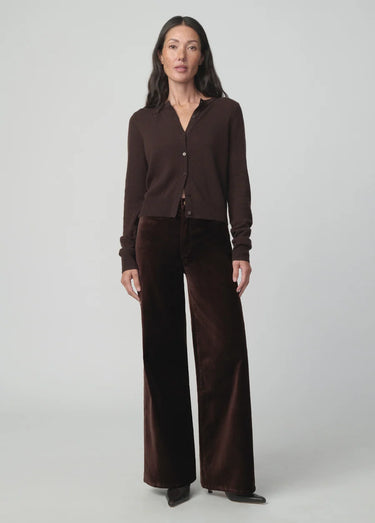Chocolate brown button-front cardigan styled with matching wide-leg velvet pants and pointed-toe shoes on a model.