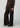 Chocolate brown button-front cardigan styled with matching wide-leg velvet pants and pointed-toe shoes on a model.