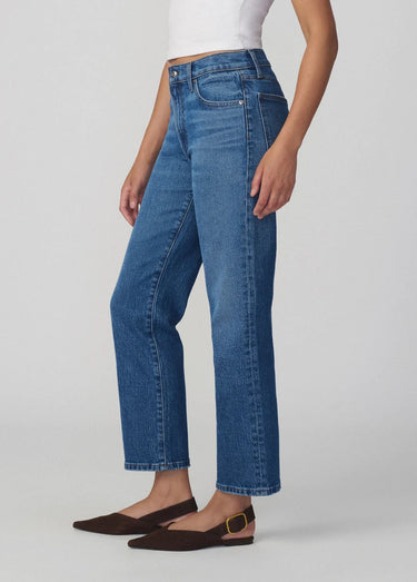 Person wearing blue jeans on a white background