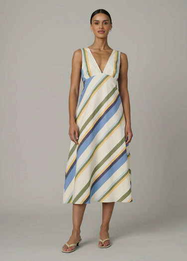 Woman wearing a striped dress on a plain background