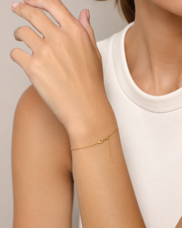 A woman wearing a dainty chain adjustable bracelet