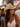 Woman wearing a straw cowboy hat at a concert with a crowd in the background