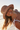 Woman wearing a straw hat and white bikini top on a sunny day.