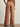 Brown wide-leg pants worn by a person on a plain background