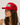 A woman wearing a red trucker-style cap with a white front patch that reads 'Spicy' in green script with a red chili pepper graphic. The cap has red mesh side panels.