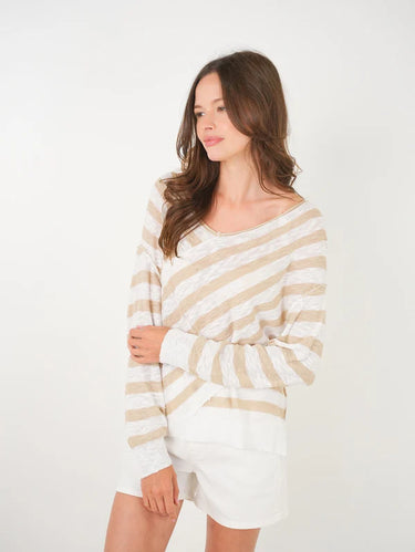 Woman wearing a striped sweater and shorts on a white background