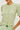 a woman wearing a green short sleeve sweater with ruffle trimmed puff sleeves