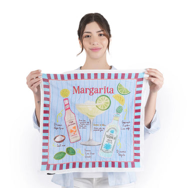 Person holding a towel with a margarita design and text.