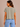 a woman wearing a crewneck cropped boxy fit tee in pale army green with jeans on a neutral background