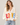 A woman wearing a beige v-neck cardigan with “LOVE” written in multi-colored letters at the middle of the sweater