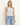 a woman wearing a grey shine crop tank with ruched side detailing on a white background