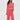 Woman wearing a pink textured top and pants on a white background