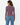 A woman shown from the back wearing a fitted, long-sleeve crewneck top in a muted mauve-purple color, paired with blue jeans, against a plain white studio background.