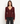 a woman wearing a burgundy ribbed v-neck cardigan and blue jeans on a white background.