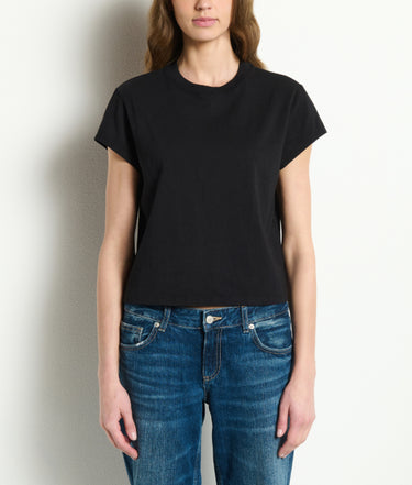 Person wearing a black t-shirt and blue jeans against a plain background
