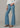 A woman wearing high rise flare blue jeans