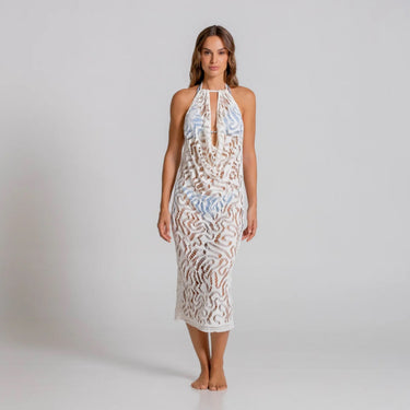 Woman wearing a white lace dress on a plain background
