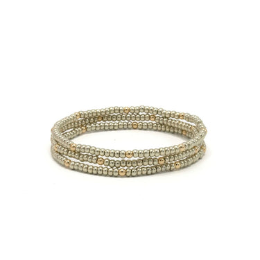 Set of three beaded platinum bracelets on a white background