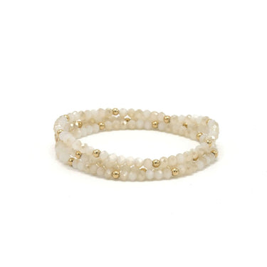 White Beaded bracelet with gold filled accent beads on a white background