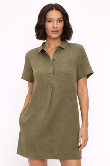 Woman wearing an olive green dress on a white background