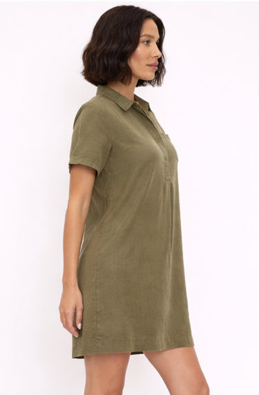 Woman wearing a green dress against a white background