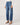 Person wearing blue jeans on a plain background