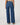 Person wearing blue wide-leg jeans on a white background