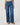 Person wearing blue jeans on a plain background