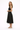Woman wearing a black sleeveless dress on a white background