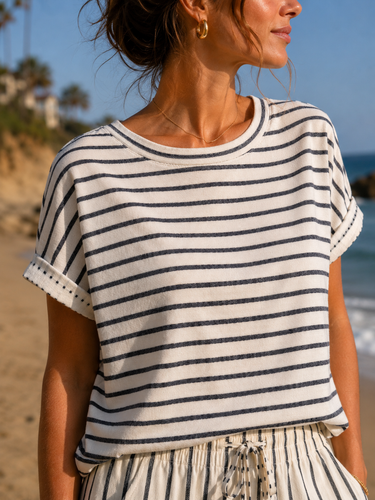 Woman wearing a striped shirt on a beach