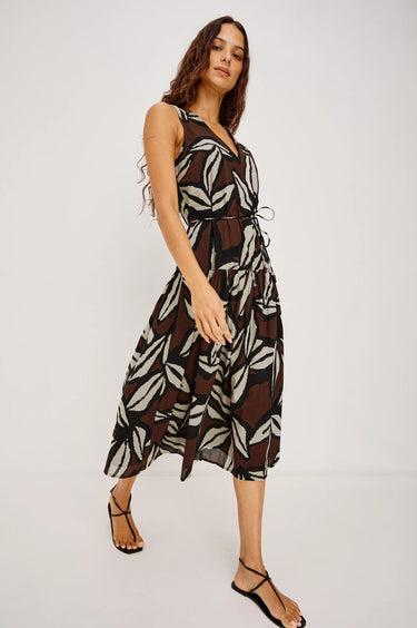 Woman wearing a patterned dress on a white background