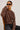 Person wearing a leopard print sweater against a plain background