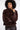 Woman wearing a brown fur coat against a white background
