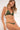 Woman wearing a green bikini against a white background