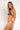 Woman wearing a green bikini against a white background